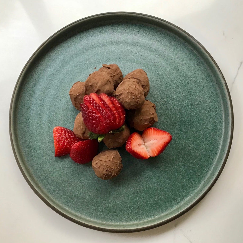chocolate truffels and strawberries on plate